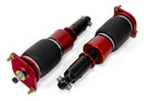 A pair of red and black Air Lift Performance red accented threaded body air-over shocks with progressive rate sleeve-style air springs.