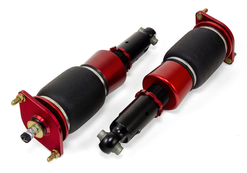 A pair of red and black Air Lift Performance red accented threaded body air-over shocks with progressive rate sleeve-style air springs. 