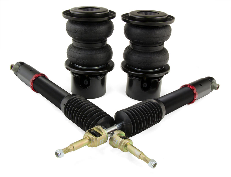 A pair of Air Lift Performance red accented threaded body monotube shocks with anodized aluminum accented double bellows progressive rate air springs, roll plates and powdercoated gloss black steel brackets. Air suspension kit part