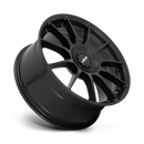 Tilted side view of a Rotiform DTM monoblock cast aluminum 11 spoke automotive wheel in a satin black finish with a Rotiform black center cap having a silver Rotiform logo.