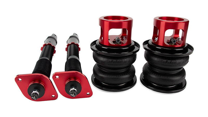A pair of Air Lift Performance red accented monotube struts with double bellows progressive rate air springs with integrated roll plates. Air suspension kit part