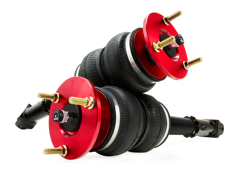 A pair of Air Lift Performance red accented monotube struts with double bellows progressive rate air springs and powdercoated gloss black steel mounting brackets. Air suspension kit part