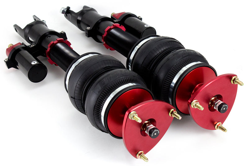 A pair of Air Lift Performance red accented monotube struts with independent adjusters for compression and rebound damping as well as piggyback style nitrogen canisters, and compact double bellows progressive rate air springs.  Air suspension kit part