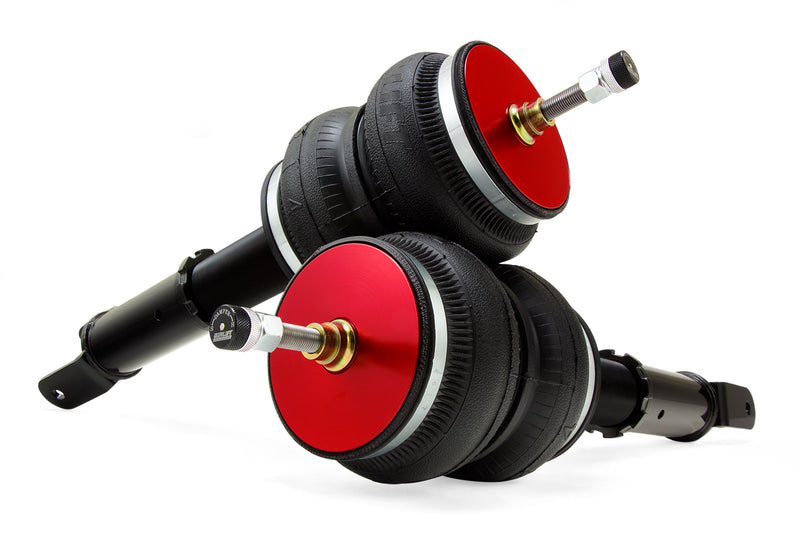 A pair of Air Lift Performance red accented monotube struts with double bellows progressive rate air springs with powdercoated gloss black steel brackets.  Air suspension kit part