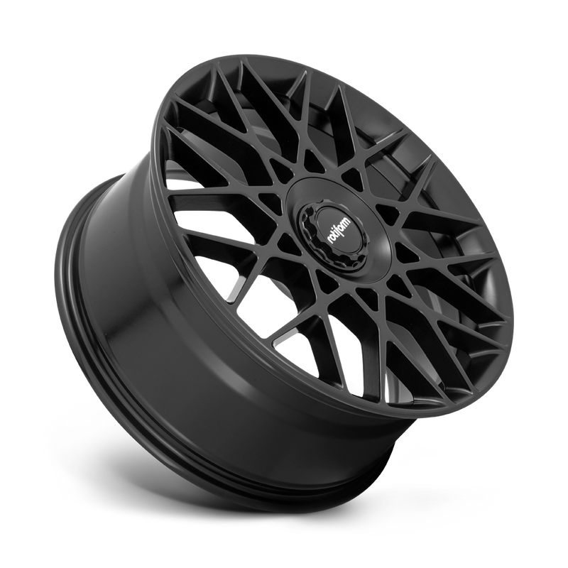 Tilted side view of a Rotiform BLQ-C monoblock cast aluminum multi spoke automotive wheel in a matte black finish with a black center cap with a silver Rotiform logo.