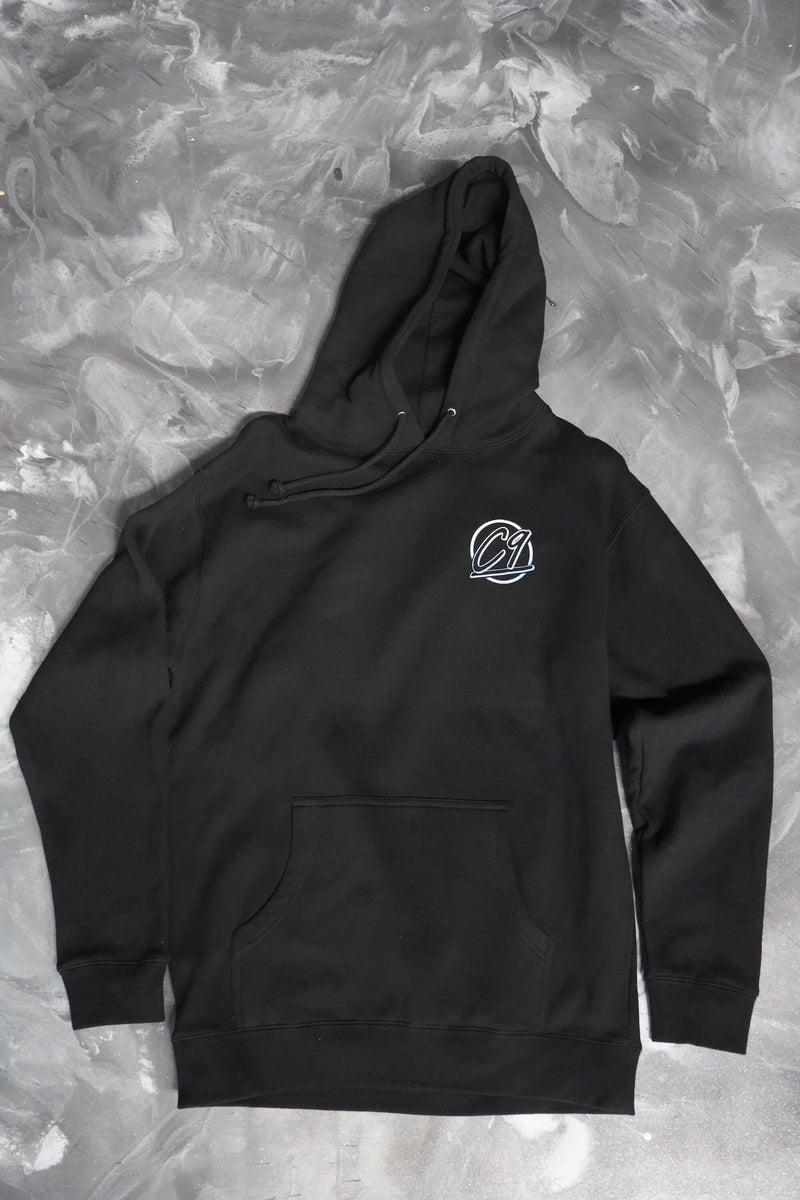Front of a black hoodie with the round Cloud 9 Automotive Brand logo below the left shoulder.