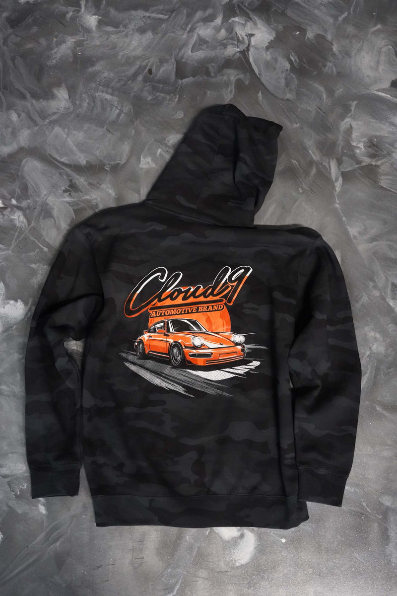 Rear of a gray camo hoodie with a orange Porsche graphic to the center with the Cloud 9 Automotive Brand logo above.