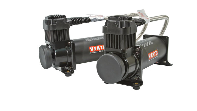 Two black VIAIR compressors with fitted braided leader hoses.