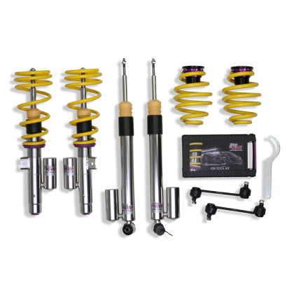 2 assembled vehicle suspension chrome body coilovers with yellow springs, 2 chrome body coilovers and 2 yellow springs with purple fittings, end links, 1 coilover adjustment tool and storage box.