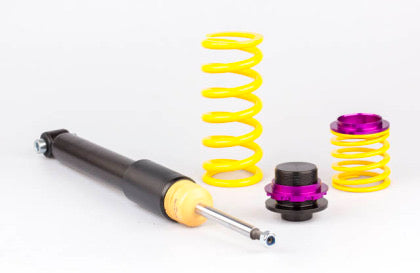 1 vehicle suspension black coilover bod, 1 large and 1 small yellow spring with black and purple fittings.