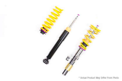 1 vehicle suspension chrome body coilover with yellow spring and purple accented fittings, 1 black body coilover and 1 yellow spring with purple accented fitting.
