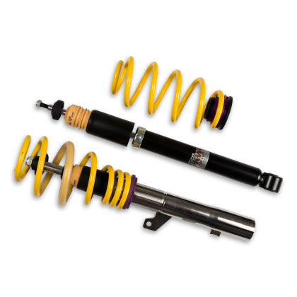 1 chrome cehicle suspension coilover with yellow spring, 1 black coilover and 1 yellow spring with purple end fitting.
