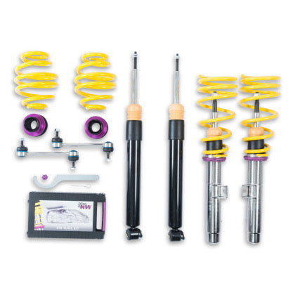 2 vehicle suspension chrome coilovers with yellow springs and purple accents, 2 black coilovers and 2 yellow springs, 2 purple accented adjustment fittingsm 2 end links and 1 coilover adjustment tool with storage box.