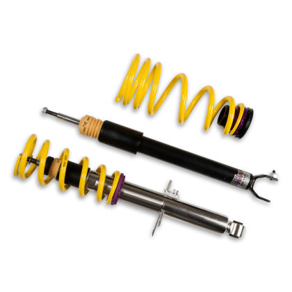 1 assembled vehicle suspension chrome coilover with yellow springs, 1 black coilover body and 1 yellow spring with end fitting installed.