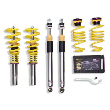 2 vehicle suspension chrome body coilovers with yellow springs and purple accented fittings, 2 chrome body coiloversm 2 yellow springs with purple fittings, 1 coilover adjustment tool and storage box.