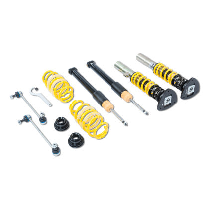 Two assembled vehicle suspension adjustable coilovers, two unsleeved coilover black struts , two yellow coilover springs and end links along with endlinks and fittings