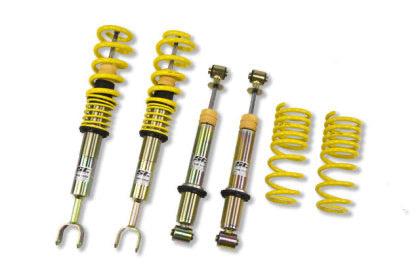 Two assembled vehicle adjustable coilovers, two coilover struts and yellow lowering springs