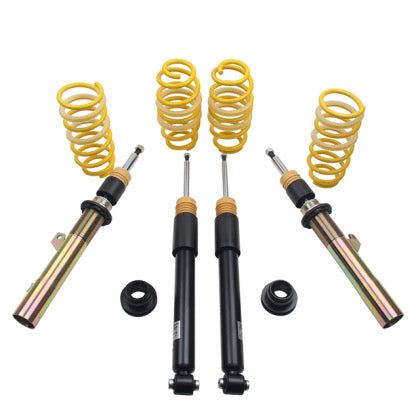 Two sleeved vehicle suspension coilovers  with two unsleeved coilover black struts and four yellow coilover springs