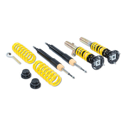 Vehicle suspension coilover kit of two assembled coilovers, two unassembled struts and two yellow lowering springs