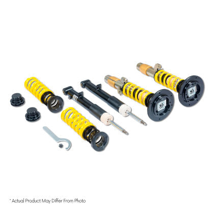 Two vehicle suspension adjustable coilovers, two unsleeved black coilover struts and two yellow coilover springs with end fittings and tool