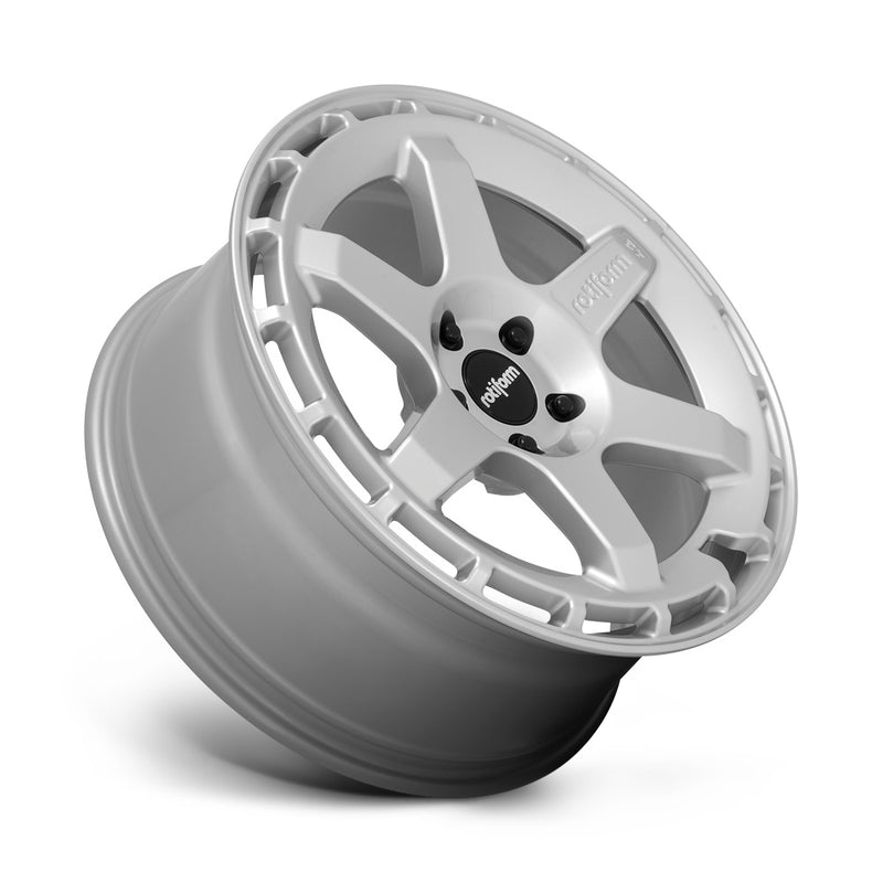 Tilted side view of a Rotiform Ken Block Signature Wheel KB1 is a cast aluminum 6 Spoke automotive wheel in a gloss silver finish with a Rotiform and Ken Block Logo embossed in one spoke along with a Rotiform silver logo center cap.
