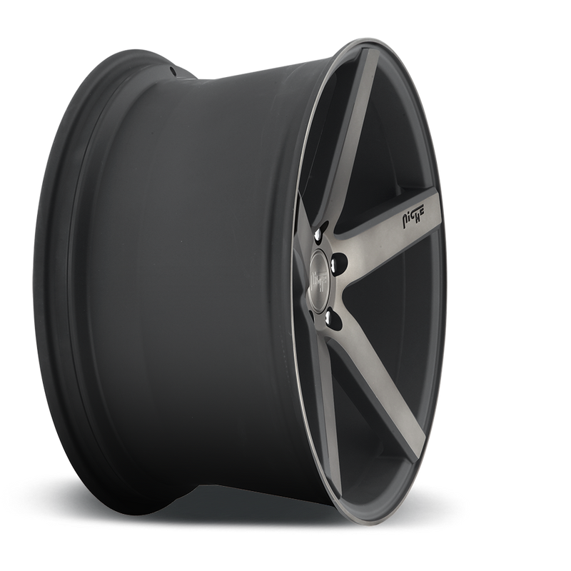 Side view of a Niche Milan monoblock cast aluminum 5 spoke automotive wheel in a matte black machined double dark tint finish with an embossed Niche logo in one spoke and a Niche silver logo center cap.