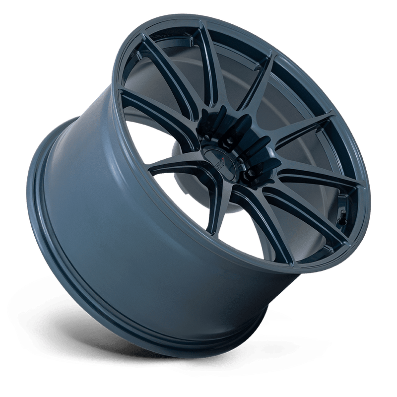 Tilted side view of a TSW Kemora flow formed 10 spoke concave profile automotive aluminum wheel in a gloss dark blue finish with a TSW logo center cap.