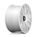 Side view of a Rotiform TUF a monoblock forged aluminum 7 Y shape spoke automotive wheel in a gloss silver finish with the word Forged embossed in the bead ring and a black center cap with a silver Rotiform logo.