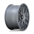 Side view of a Rotiform TUF a monoblock forged aluminum 7 Y shape spoke automotive wheel in a satin titanium finish with the word Forged embossed in the bead ring and a black center cap with a silver Rotiform logo.