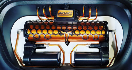 Air Lift Performance tank, manifold and compressor mounted in a Tesla.