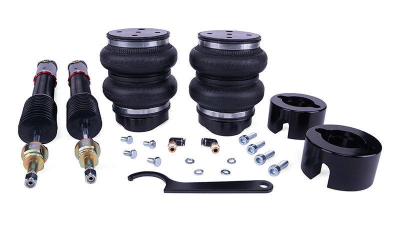 A pair of black double bellow air bags, black monotube shocks with installation fittings and tool.