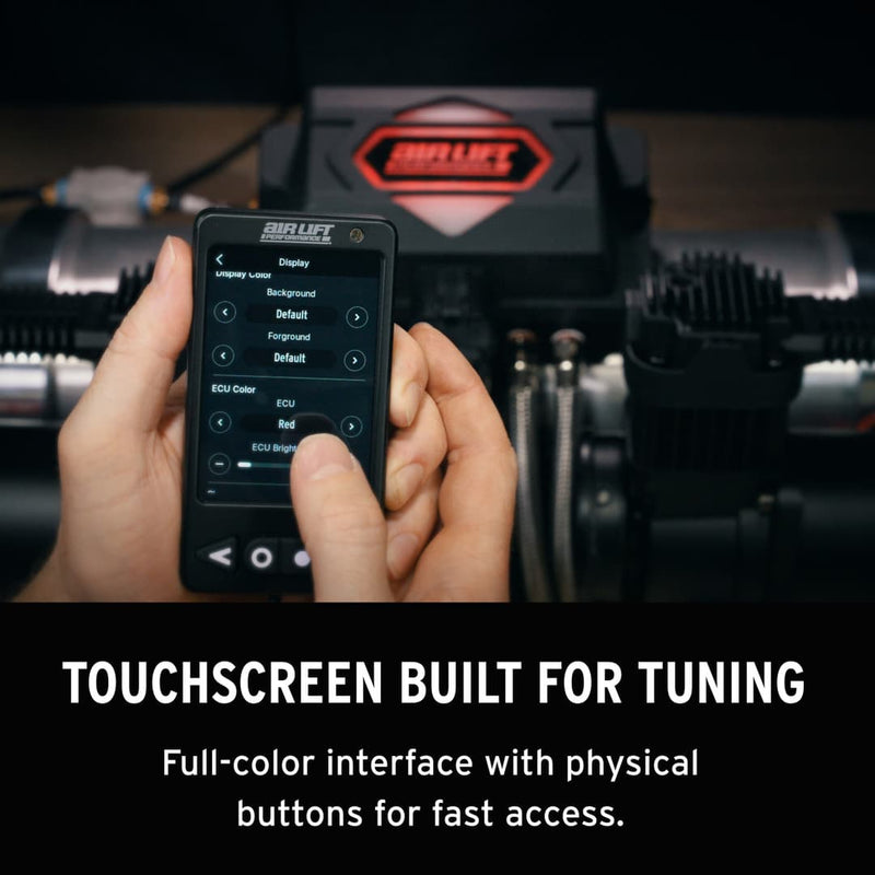 Hand holding a touchscreen device with a blurred background of Air Lift Performance management system