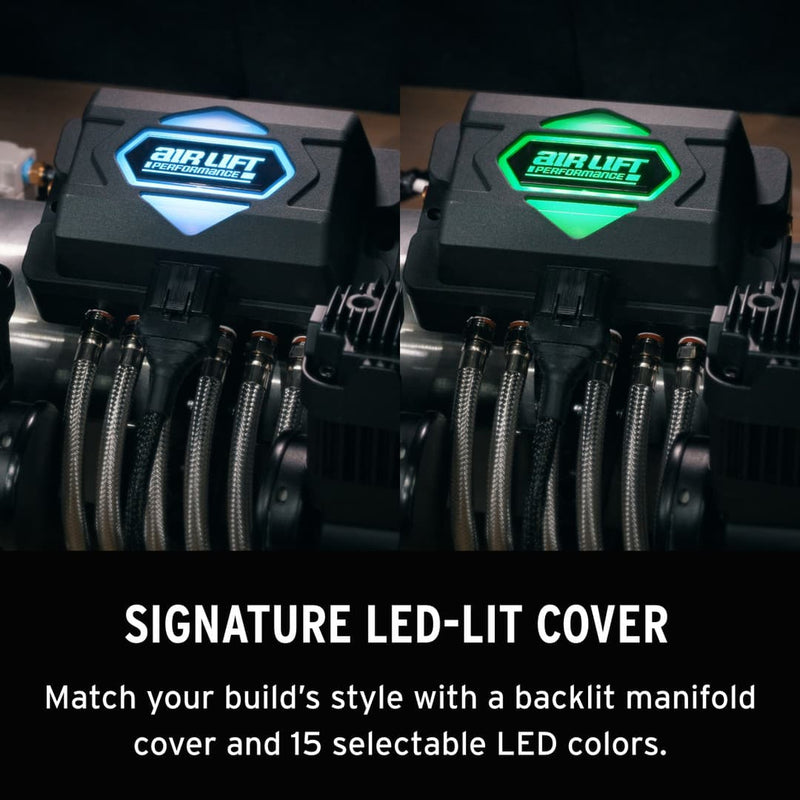 Two Air Lift Performance manifolds with LED-lit covers in blue and green on a dark background