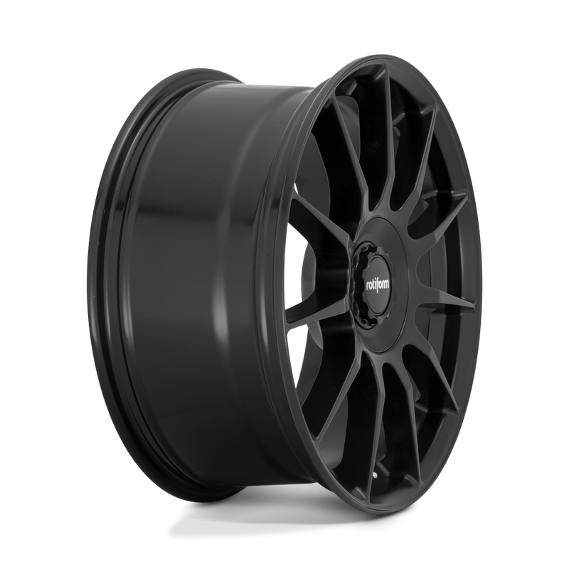 Side view of a Rotiform DTM monoblock cast aluminum 11 spoke automotive wheel in a satin black finish with a Rotiform black center cap having a silver Rotiform logo.