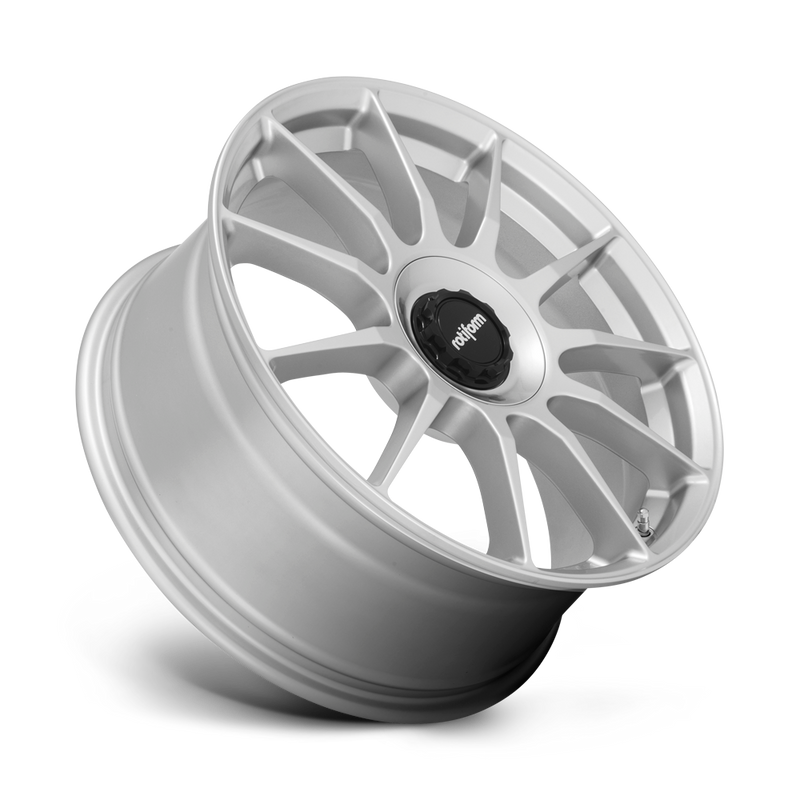 Tilted side view of a Rotiform DTM monoblock cast aluminum 11 spoke automotive wheel in a silver finish with a Rotiform black center cap.