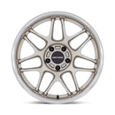 Front view of a Motegi model Tsubake automotive wheel in motorsports gold with a machined lip and black motegi logo center cap