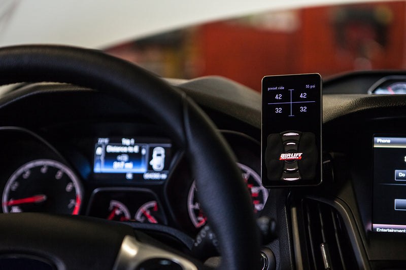 The Air Lift Performance 3H/3P air management system digital display controller mounted on the right hand side of the steering wheel in a vertical position.