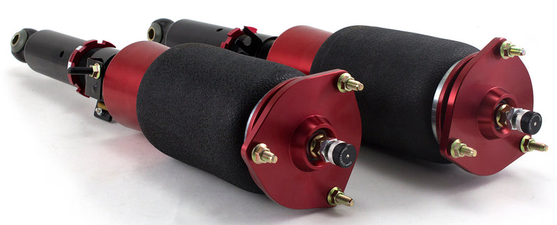A pair of Air Lift Performance red accented threaded body air-over shocks with progressive rate sleeve-style air springs. Air suspension kit part