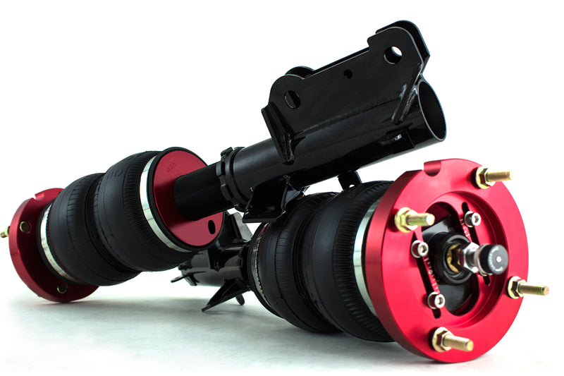 A pair of Air Lift Performance anodized red aluminum accented threaded monotube struts with double bellows progressive rate air springs with adjustable camber plates and powdercoated gloss black steel mounting brackets. Air suspension kit part