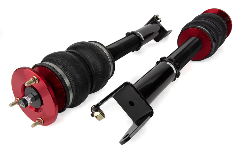 A pair of Air Lift Performance threaded monotube struts with double bellows progressive rate air springs with anodized red aluminum accents and mounting brackets.  Air suspension part