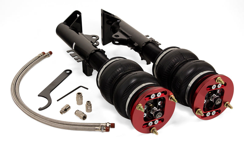 A pair of Air Lift Performance red accented monotube shocks with double bellows progressive rate air springs with adjustable camber plates, powdercoated gloss black steel brackets, pair of stainless steel leader hoses and fittings. Air suspension kit part