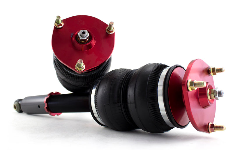 A pair of Air Lift Performance anodized red aluminum accented monotube struts with double bellows progressive rate air springs with red anodized aluminum upper mounts. Air suspension kit part