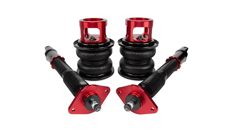 A pair of Air Lift Performance anodized red aluminum accented monotube shocks with double bellows progressive rate air springs with roll plates. Air suspension part kit
