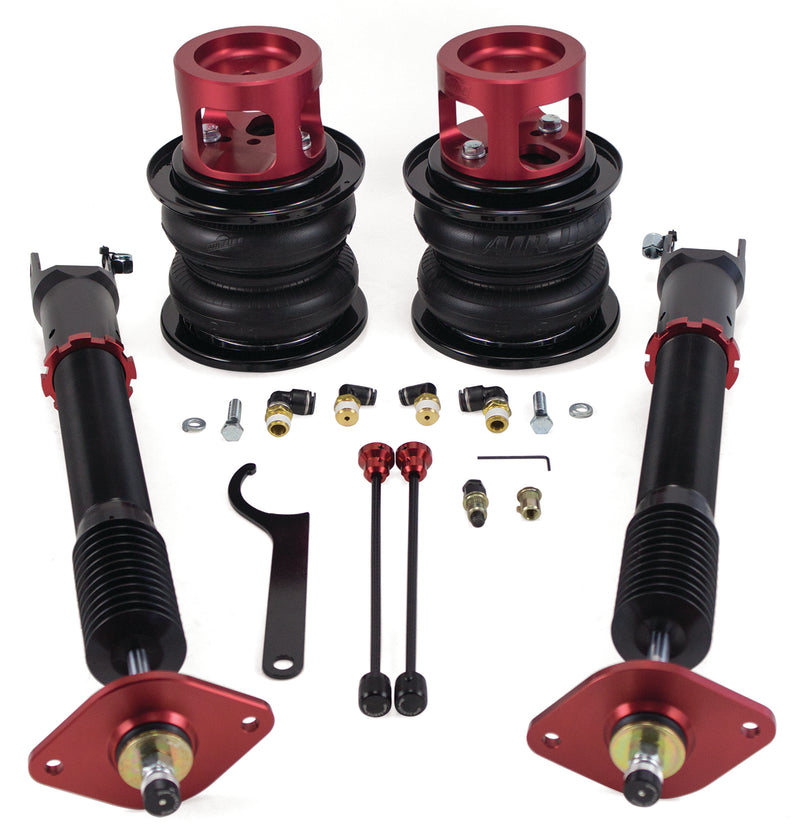 A pair of Air Lift Performance red accented monotube struts and double bellows progressive rate air springs with red anodized aluminum upper mounts and roll plates. Fittings for installation. Air suspension kit part