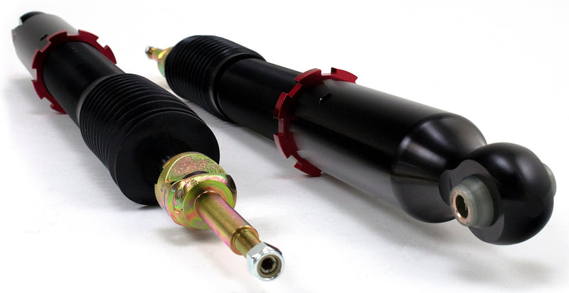 A pair of Air Lift Performance red accented threaded body shocks. 