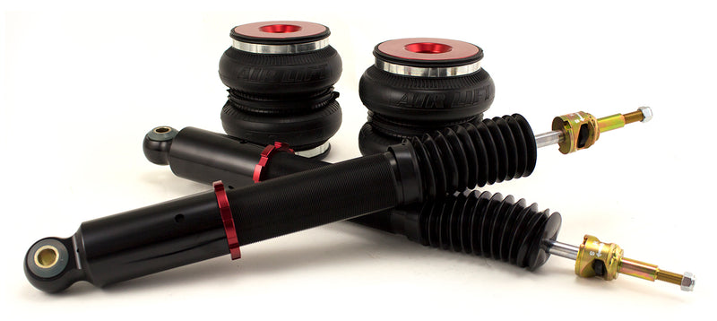 A pair of Air Lift Performance red accented threaded body air-over monotube shocks and double bellows progressive rate air springs. Air suspension kit part