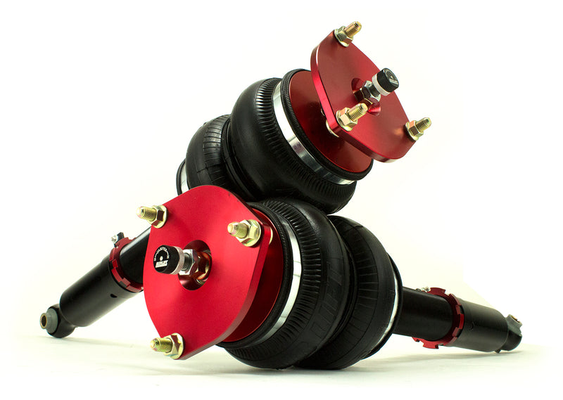 A pair of Air Lift Performance red accented monotube struts with compact double bellows progressive rate air springs. Air suspension kit part