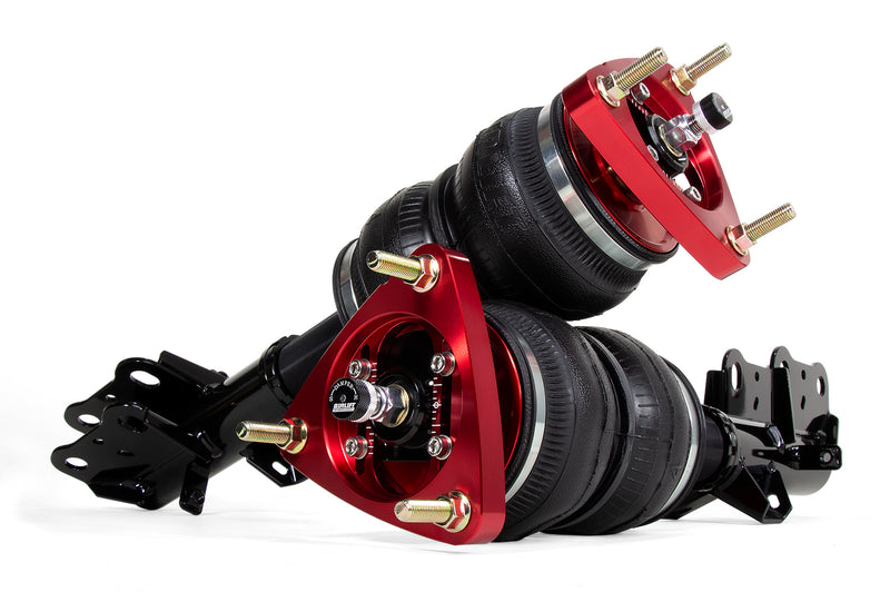 A pair of Air Lift Performance red accented monotube shocks with double bellows progressive rate air springs with adjustable camber plates. Air suspension kit part