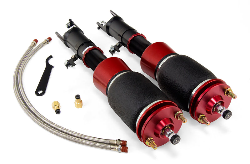 A pair of Air Lift Performance red accented threaded body air-over shocks with progressive rate sleeve-style air springs along with stainless steel leader hoses and mounting hardware. Air suspension kit part