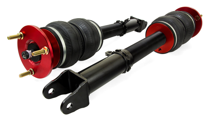 A pair of Air Lift Performance red accented monotube struts with double bellows progressive rate air springs and powdercoated gloss black steel mounting brackets. Air suspension kit part